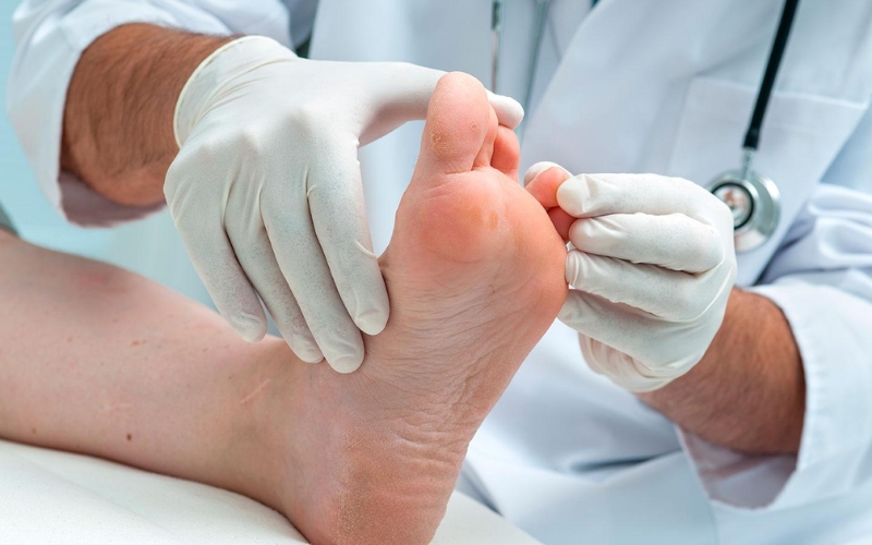 Specialist examining a diabetic patient's foot